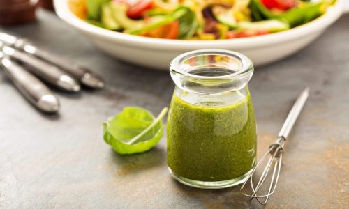 Healthy green goddess salad dressing with herbs, garlic and olive oil
