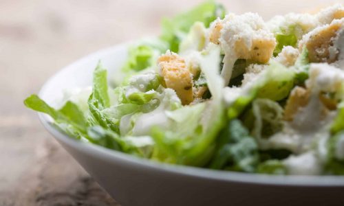 Ceasar salad with lots of dressing and parmesan